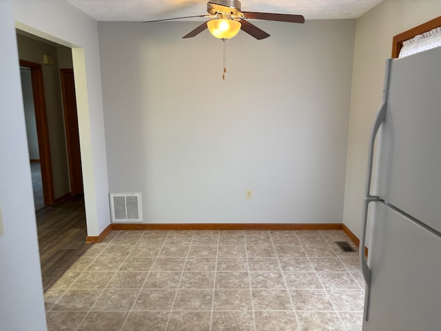 spare room featuring light wood-type flooring, a textured ceiling, and ceiling fan