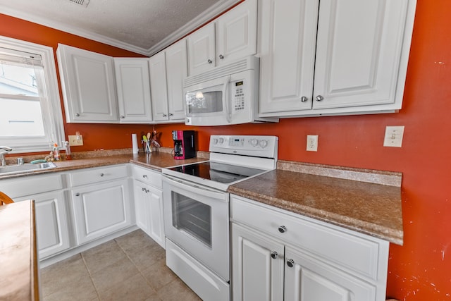 kitchen with crown molding, white cabinets, a textured ceiling, and white appliances