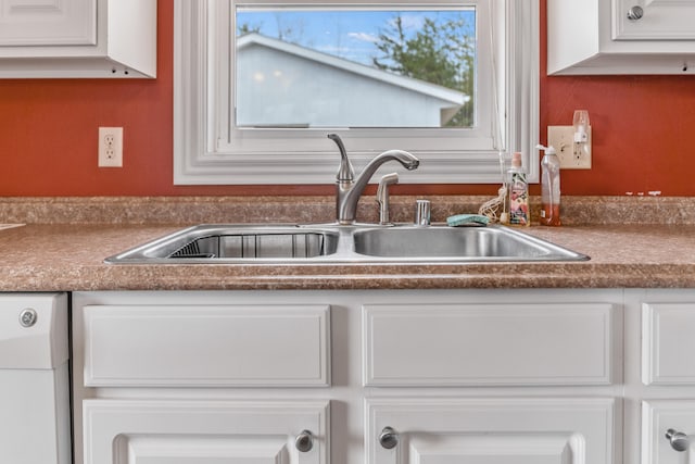 kitchen with white cabinetry and sink