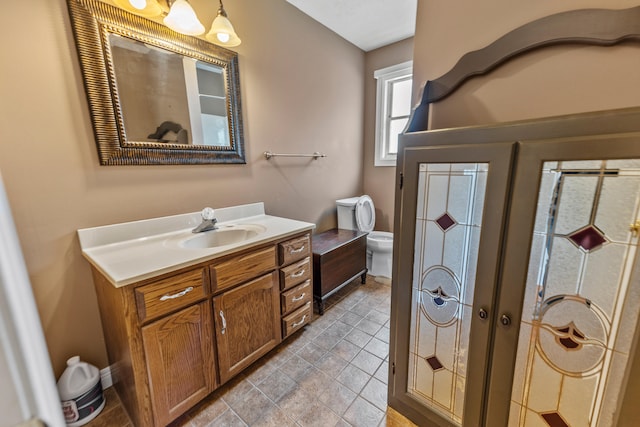 bathroom featuring toilet, french doors, and vanity