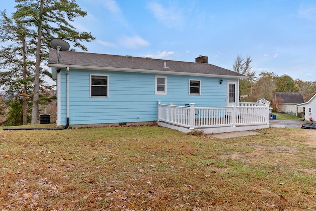 back of house with a wooden deck, central air condition unit, and a lawn