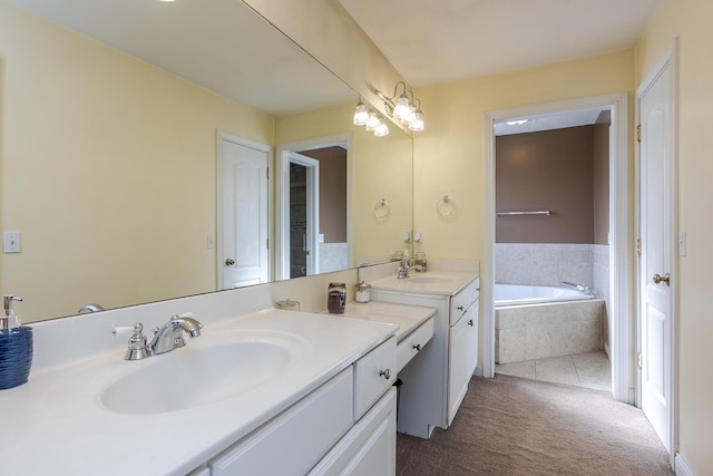 bathroom with vanity and tiled tub