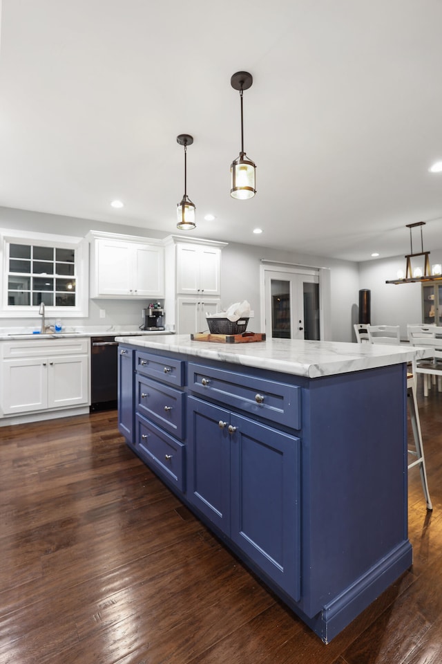 kitchen featuring white cabinetry, decorative light fixtures, blue cabinetry, dark hardwood / wood-style flooring, and dishwasher