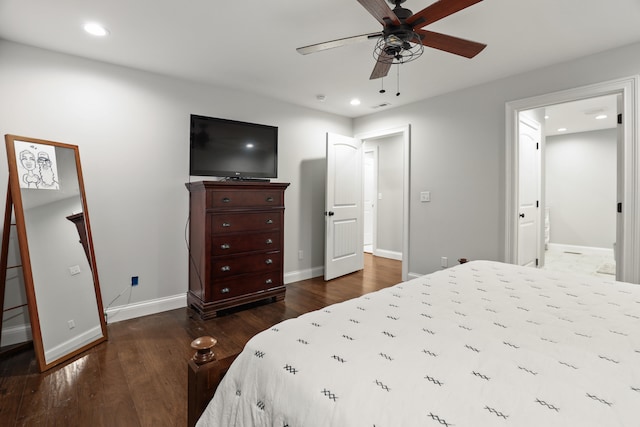 bedroom with wood-type flooring, ceiling fan, and ensuite bath