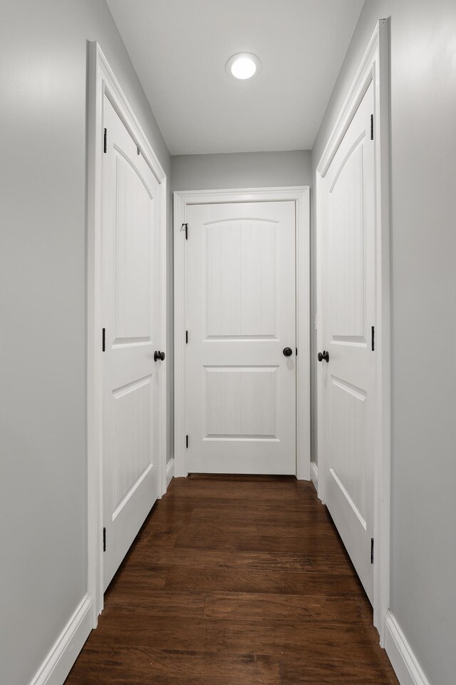 hallway featuring dark hardwood / wood-style flooring