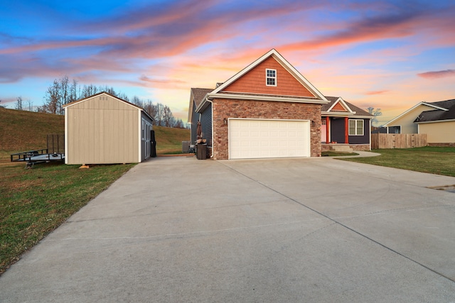 view of front of property with a garage and a lawn