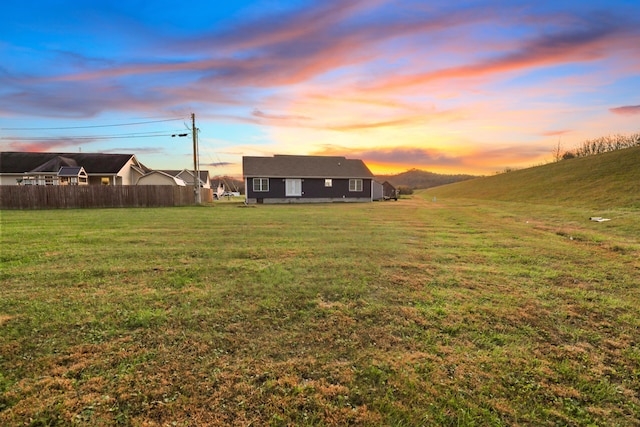 view of yard at dusk