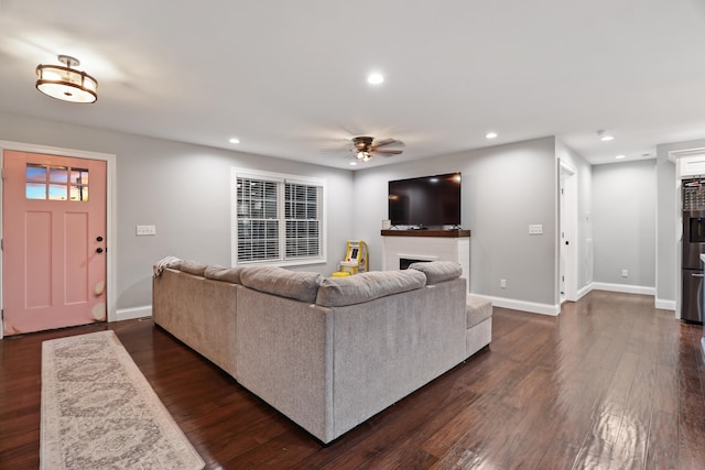 living room with ceiling fan and dark hardwood / wood-style floors