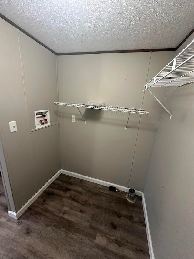 laundry area with hookup for a washing machine, a textured ceiling, and dark hardwood / wood-style flooring