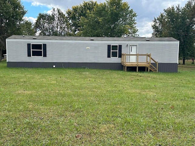 rear view of house with a yard and a deck