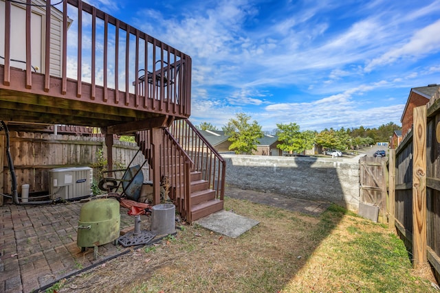 view of yard with cooling unit, a patio area, and a deck