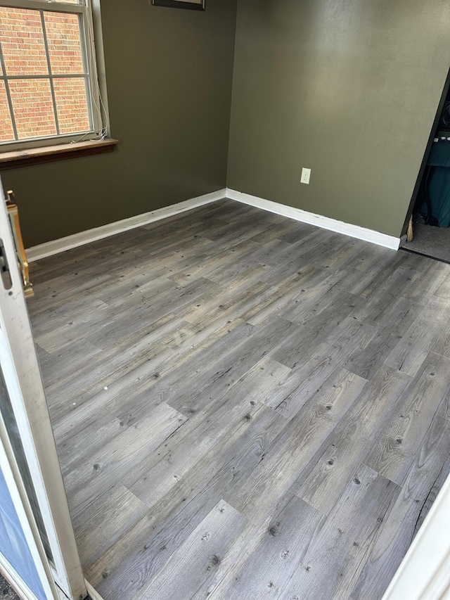 empty room with hardwood / wood-style flooring