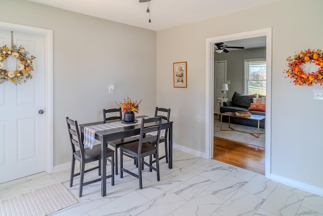 dining space with light wood-type flooring and ceiling fan