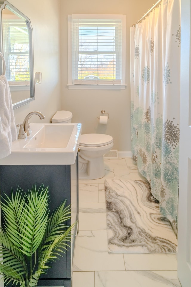 bathroom featuring vanity and toilet