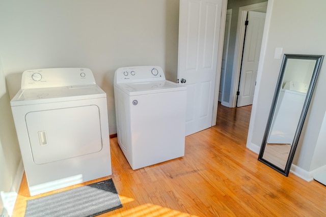 washroom featuring washer and dryer and light hardwood / wood-style flooring