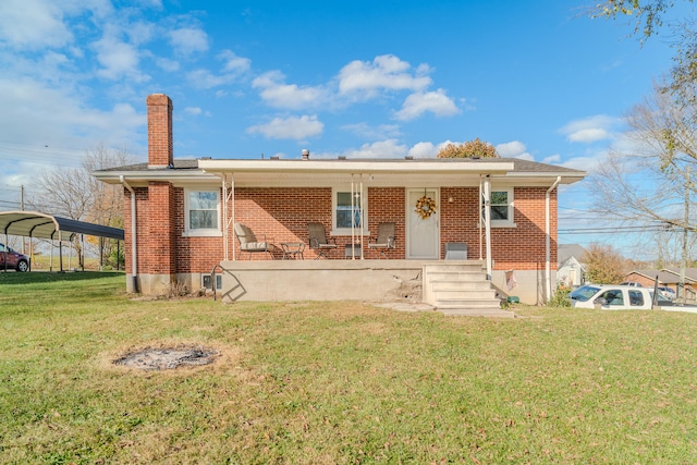 bungalow-style house with a front lawn and a carport