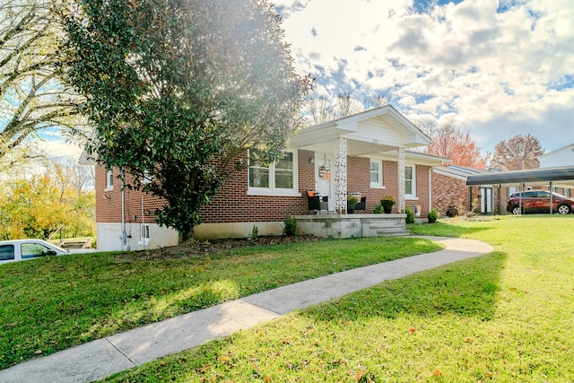 view of front facade with a carport and a front yard