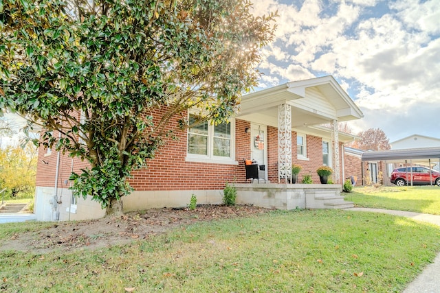 bungalow-style house featuring a carport and a front lawn