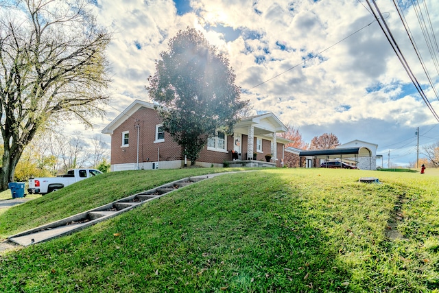 view of front of house featuring a carport and a front lawn