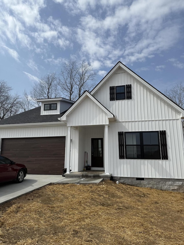 modern farmhouse featuring crawl space, an attached garage, board and batten siding, and roof with shingles