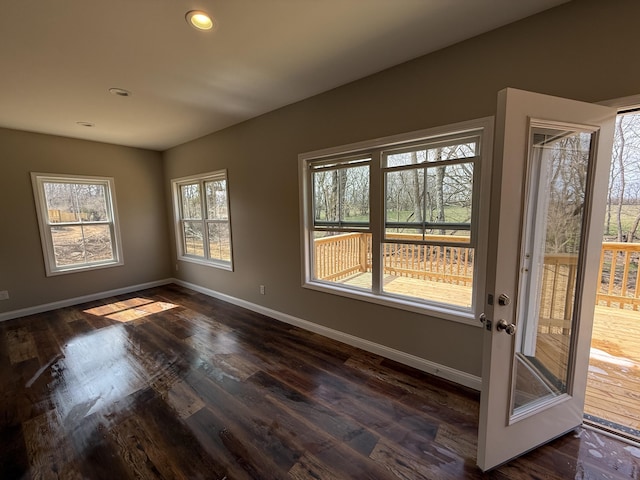 spare room with dark wood-type flooring, recessed lighting, and baseboards