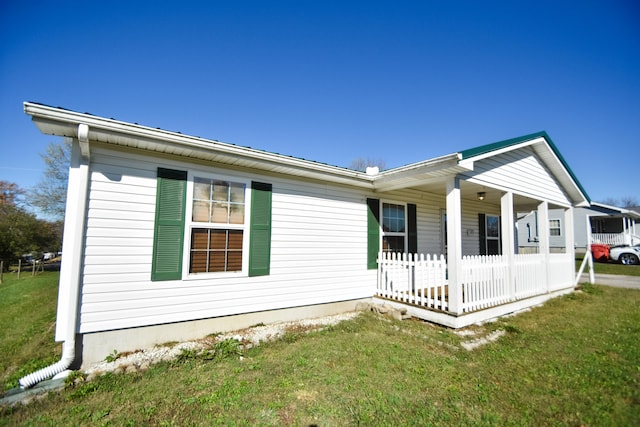 view of property exterior featuring a porch and a lawn