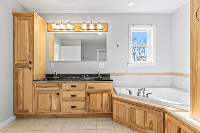 bathroom featuring a washtub, vanity, a textured ceiling, and tile patterned flooring