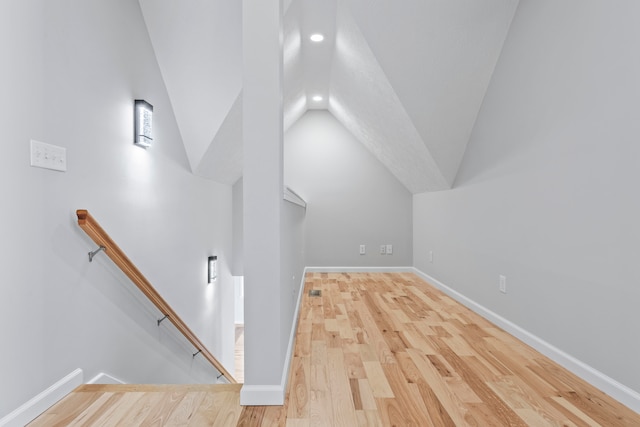 bonus room featuring light wood-type flooring and lofted ceiling