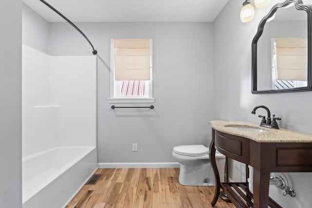 full bathroom featuring shower / tub combination, vanity, hardwood / wood-style flooring, and toilet