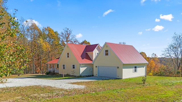 view of side of property featuring a garage and a yard