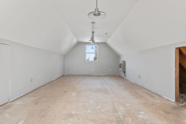 additional living space with heating unit and vaulted ceiling