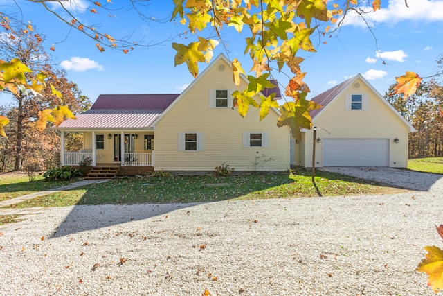 view of front of house featuring a front lawn, a garage, and a porch