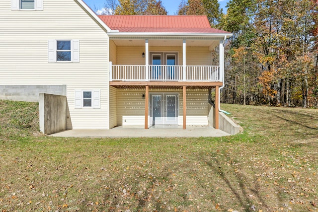 rear view of house with french doors, a yard, and a patio area