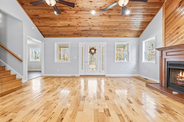 unfurnished living room with wood ceiling, light hardwood / wood-style flooring, and high vaulted ceiling