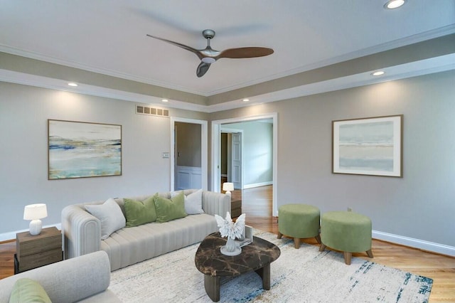 living room with ornamental molding, ceiling fan, and hardwood / wood-style flooring