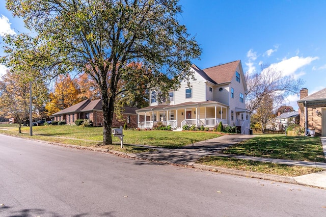 farmhouse inspired home with covered porch and a front lawn