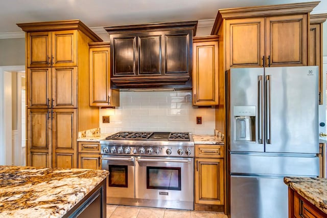 kitchen with high quality appliances, light stone countertops, ornamental molding, and backsplash