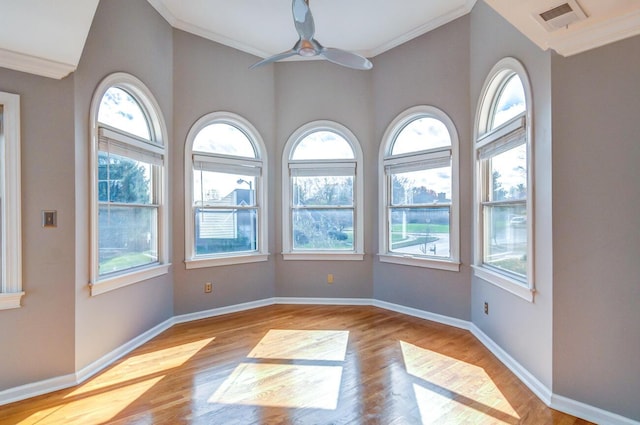 unfurnished room with ceiling fan, light wood-type flooring, and crown molding