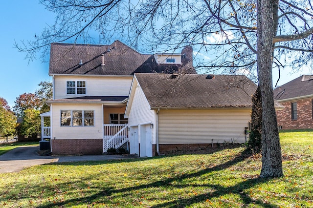 view of front of house with a porch, a front yard, and a garage