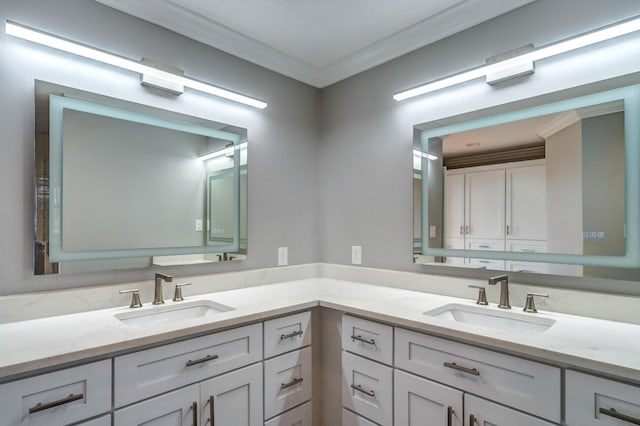 bathroom featuring ornamental molding and vanity