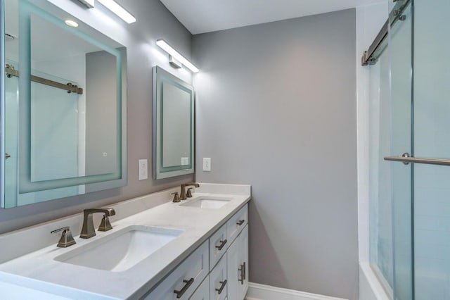 bathroom featuring a shower with shower door and vanity