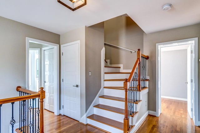 stairway featuring wood-type flooring