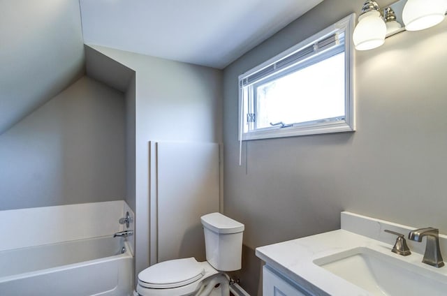 bathroom featuring toilet, vanity, and a bathtub