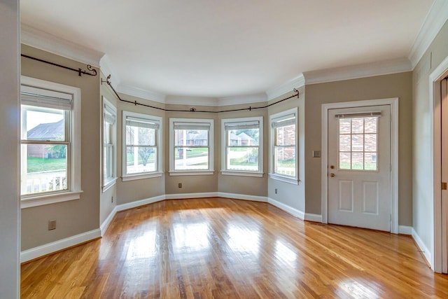 interior space featuring ornamental molding and light wood-type flooring