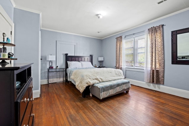 bedroom featuring crown molding and dark hardwood / wood-style flooring