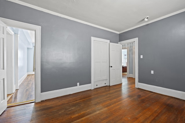 spare room with dark hardwood / wood-style flooring and crown molding