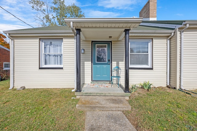 doorway to property with a yard