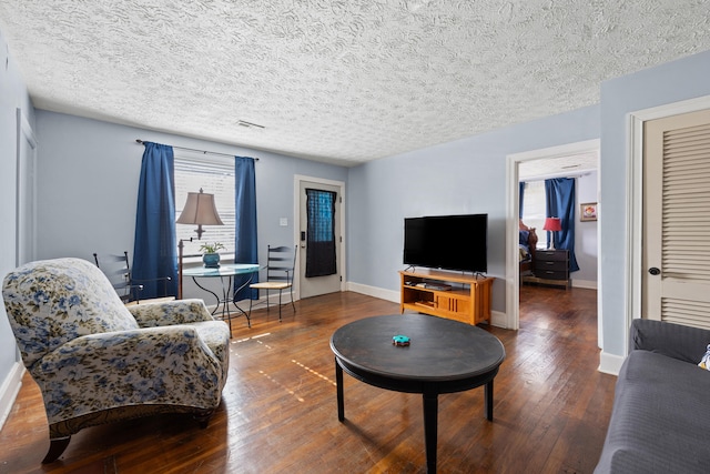 living room with a textured ceiling and hardwood / wood-style flooring