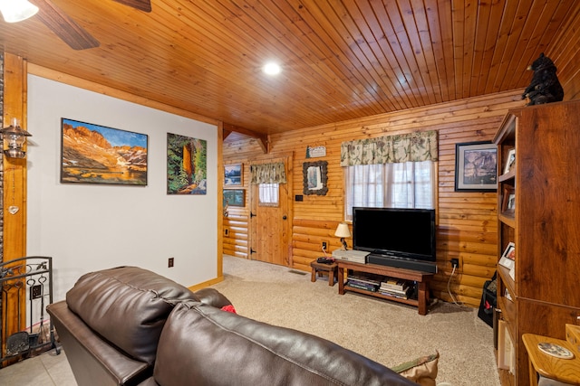 carpeted living room with wood walls, ceiling fan, and wood ceiling