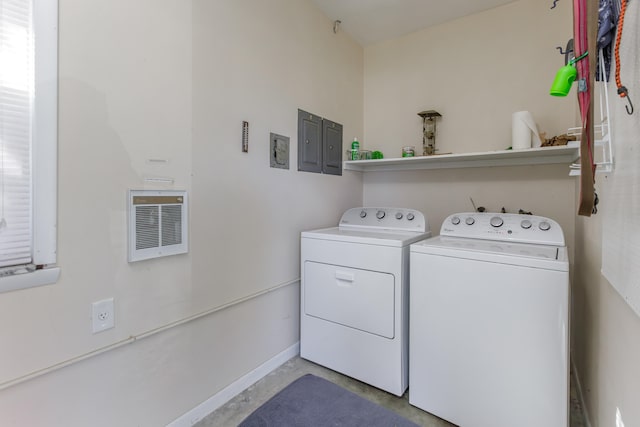 laundry room with electric panel, heating unit, and independent washer and dryer